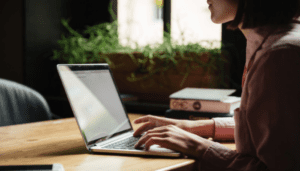 woman using laptop in office where PoSH is applicable