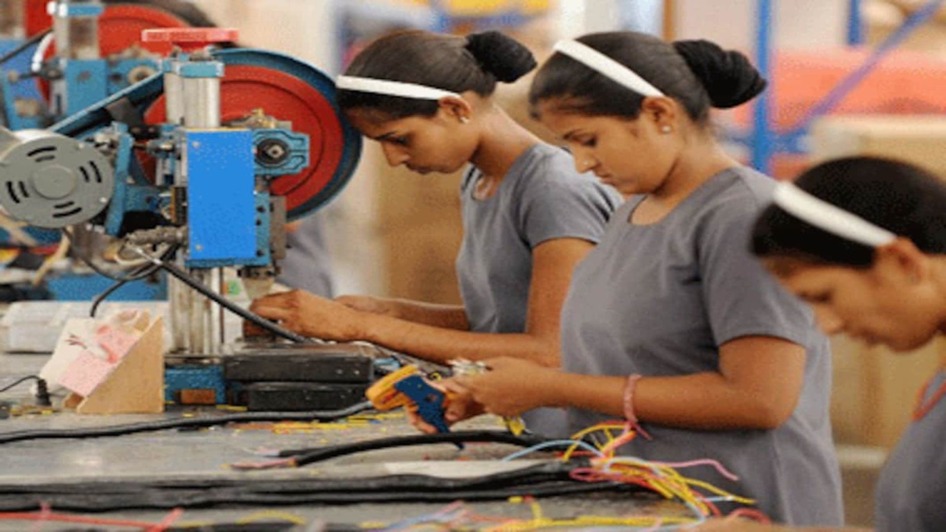 A picture of women shown working in a manufacturing factory.