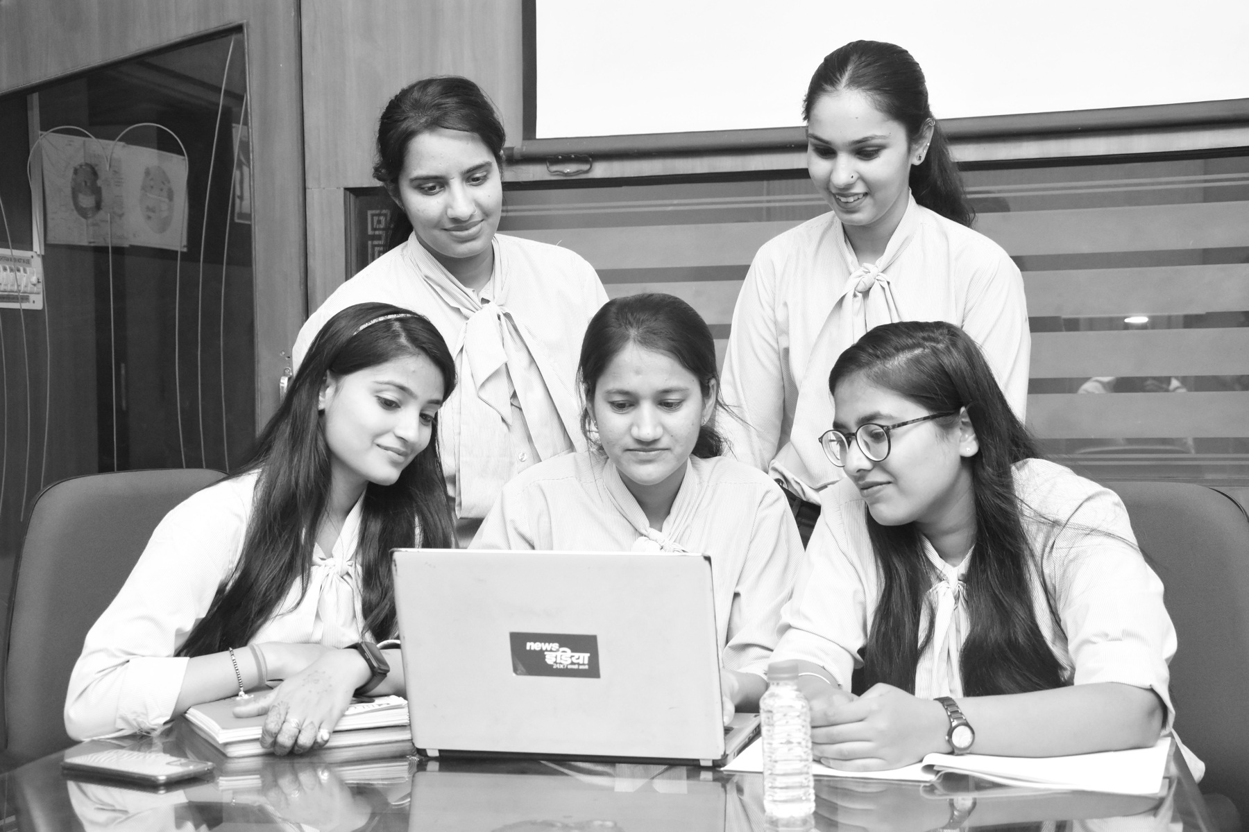 Women gathered around a laptop in a college setting in Jaipur.